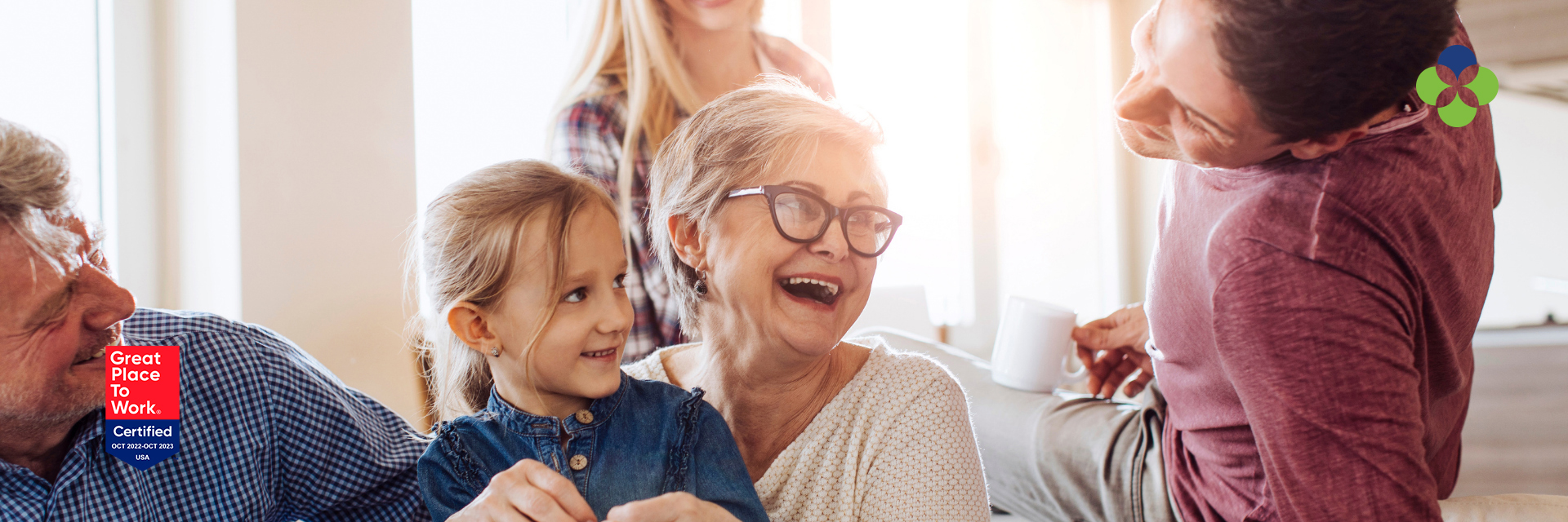 Elderly woman with younger people laughing around her