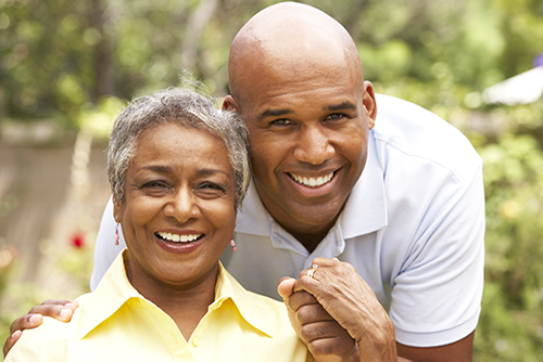 Elderly woman holding hands with her son outside