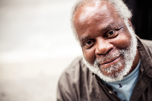 African American man smiling with a grey beard